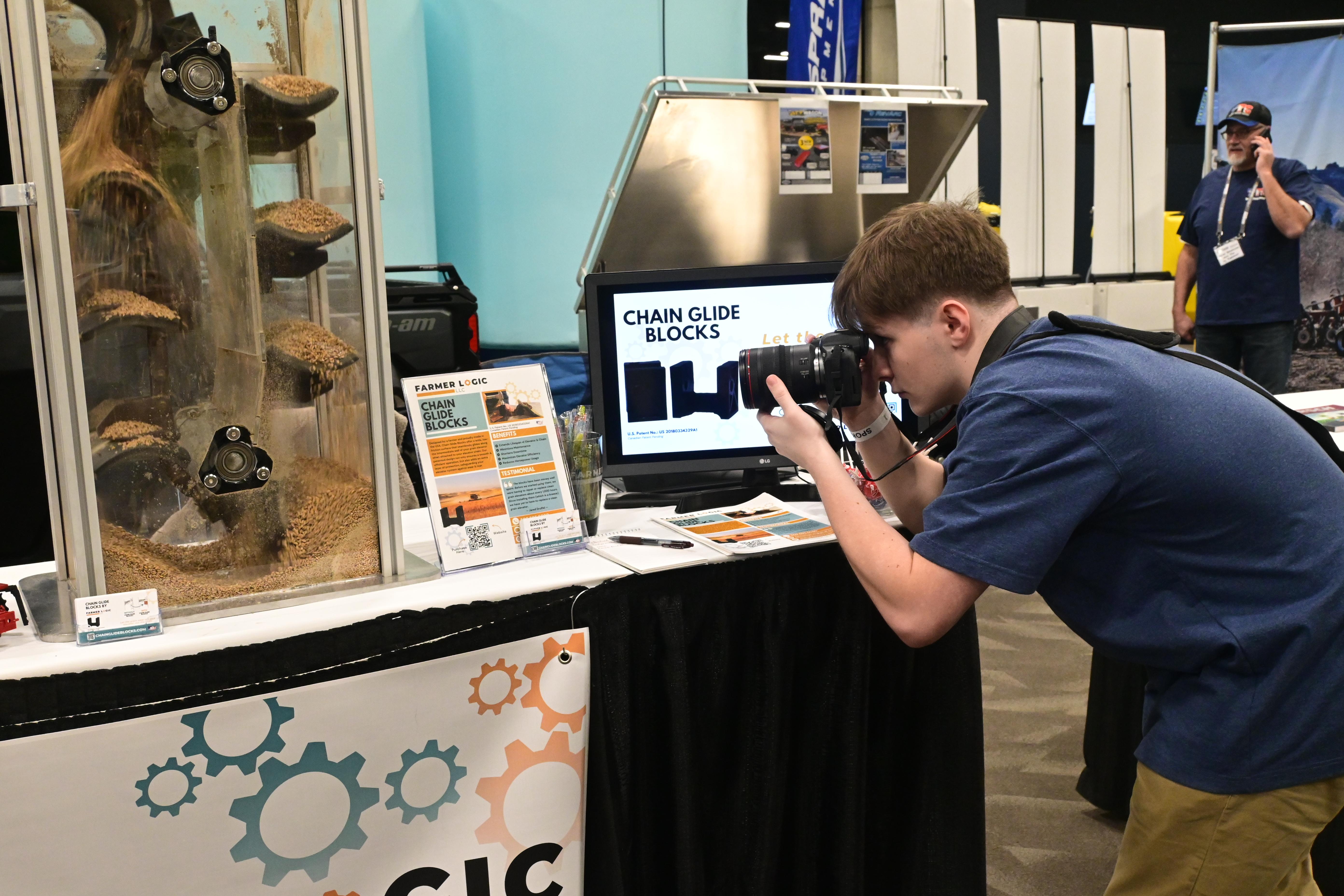 CHS senior Michael Fetter takes photos of the Ag Expo booth